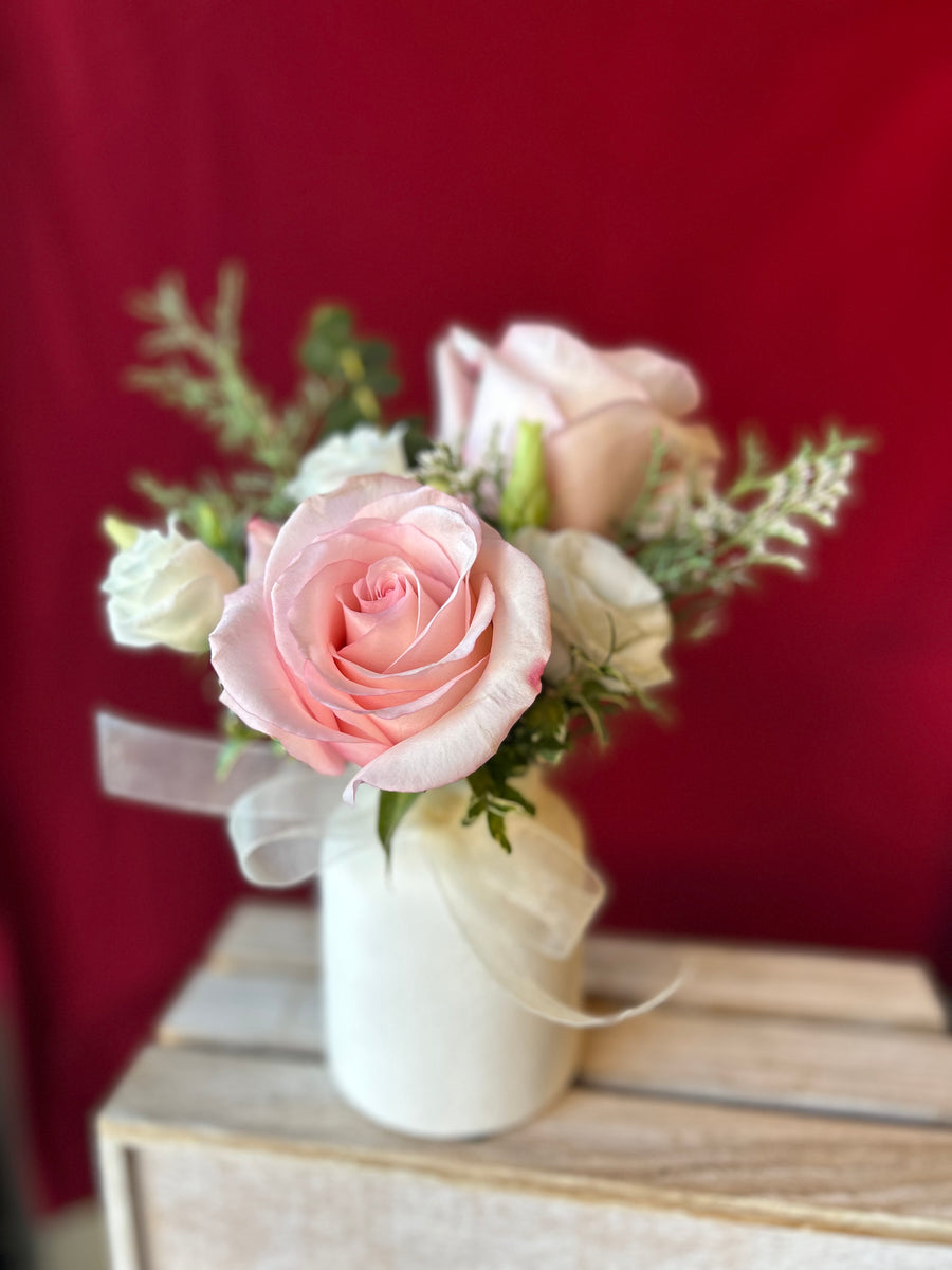 Cute valentines arrangement in white milk jar