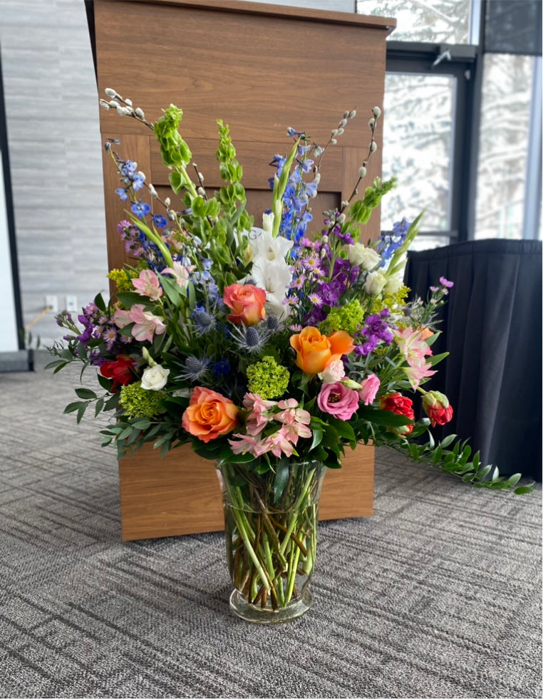 Large funeral arrangement. Bright and colorful