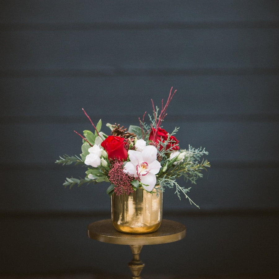 Traditional white and red arrangement in shiny gold pot