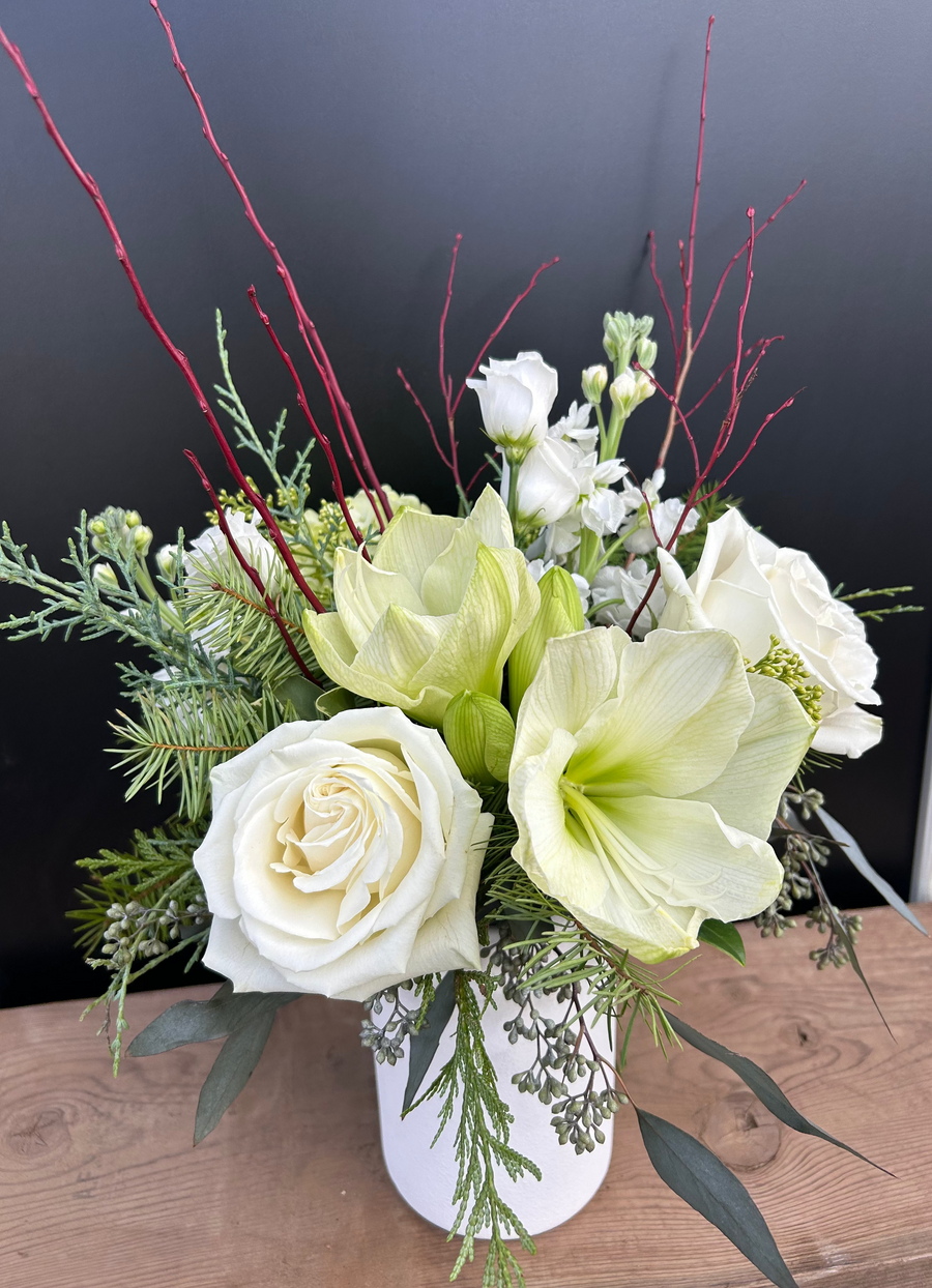 Medium white and green winter arrangement in white milk jug