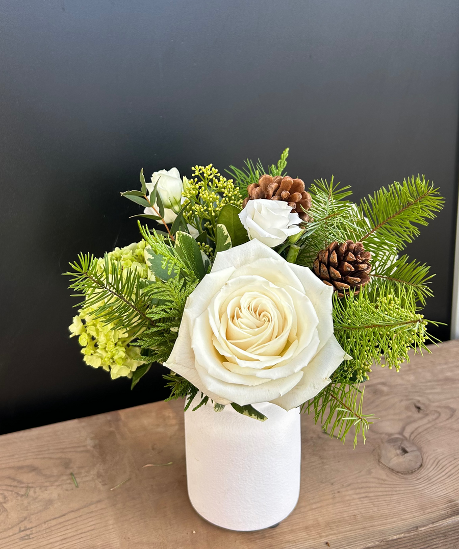 Extra small white and green winter arrangement in white milk jug