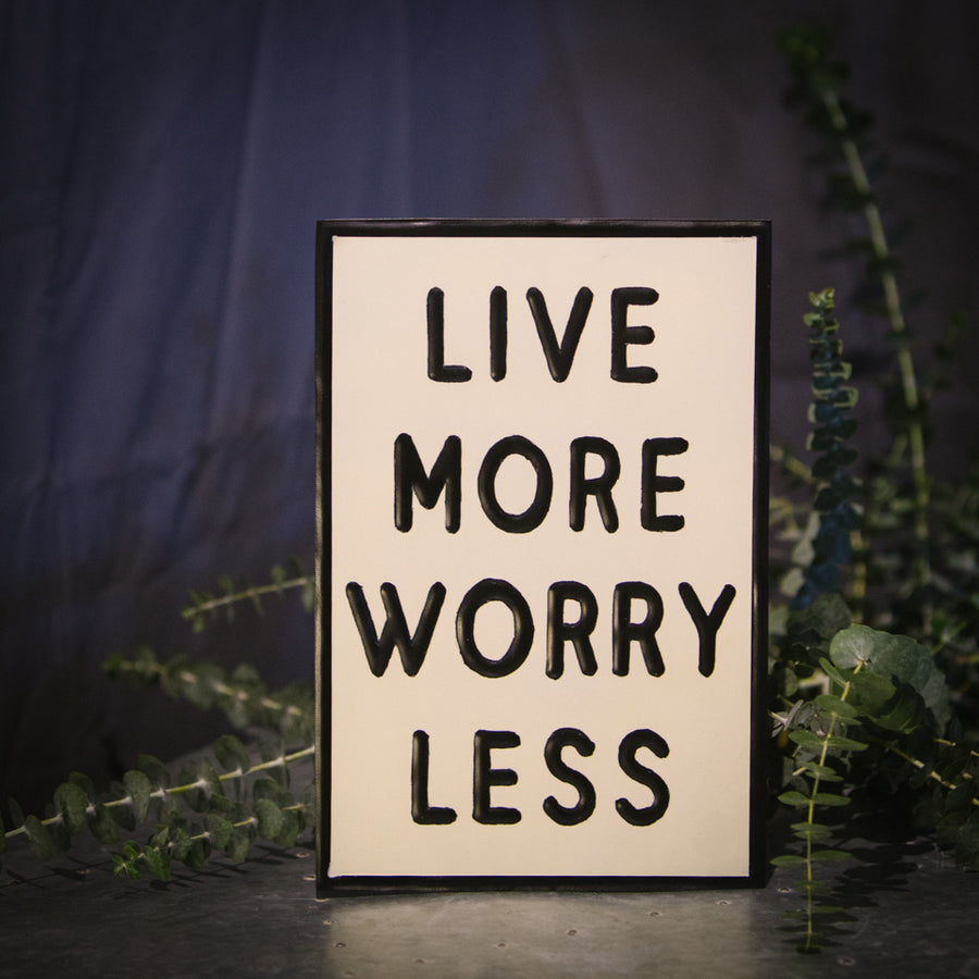“Live More Worry Less” sign