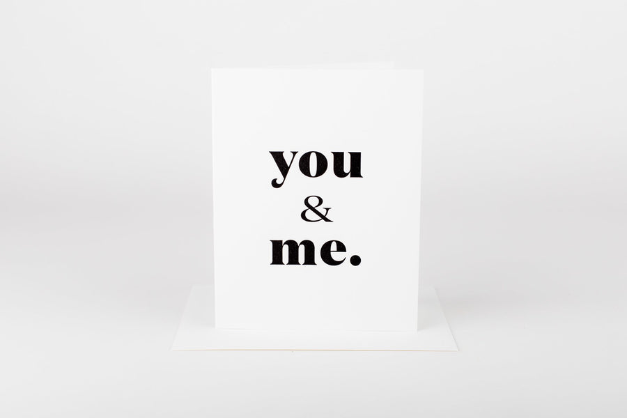 'you & me.' Black script card