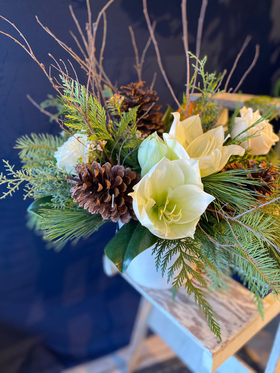 White and green natural vase with cones and twigs