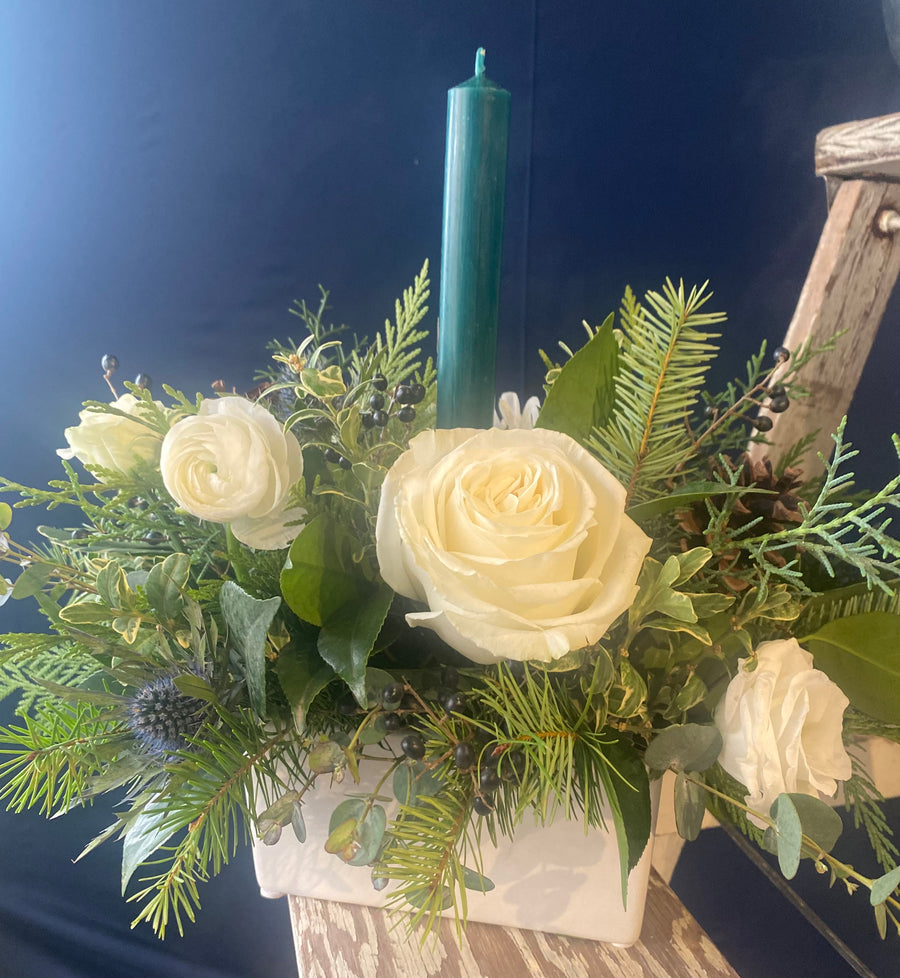 Green candle in white vase centerpiece